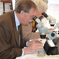 Minister Gert Lindemann am Mikroskop
