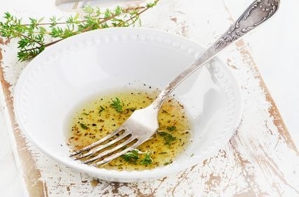 Dressing mit frischem Thymian in weißer Schüssel