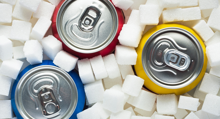 Getränkedosen stehen in Zuckerwürfeln